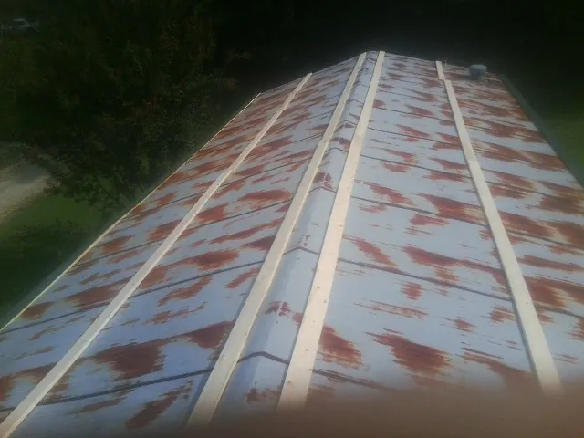 Rusted metal roof panels with new wood purlins before replacement — Storm Damage Roof Repair in Cross River by Roofing Brothers