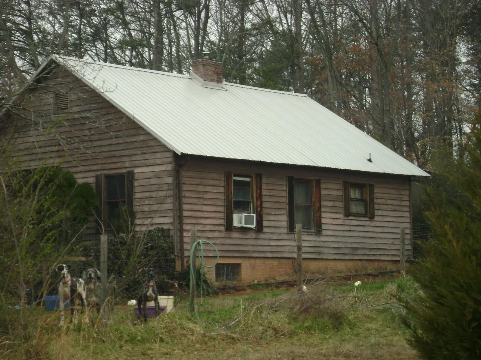 White metal roof on an old wood sided farmhouse, from a Metal Roof Installation job in Cross River