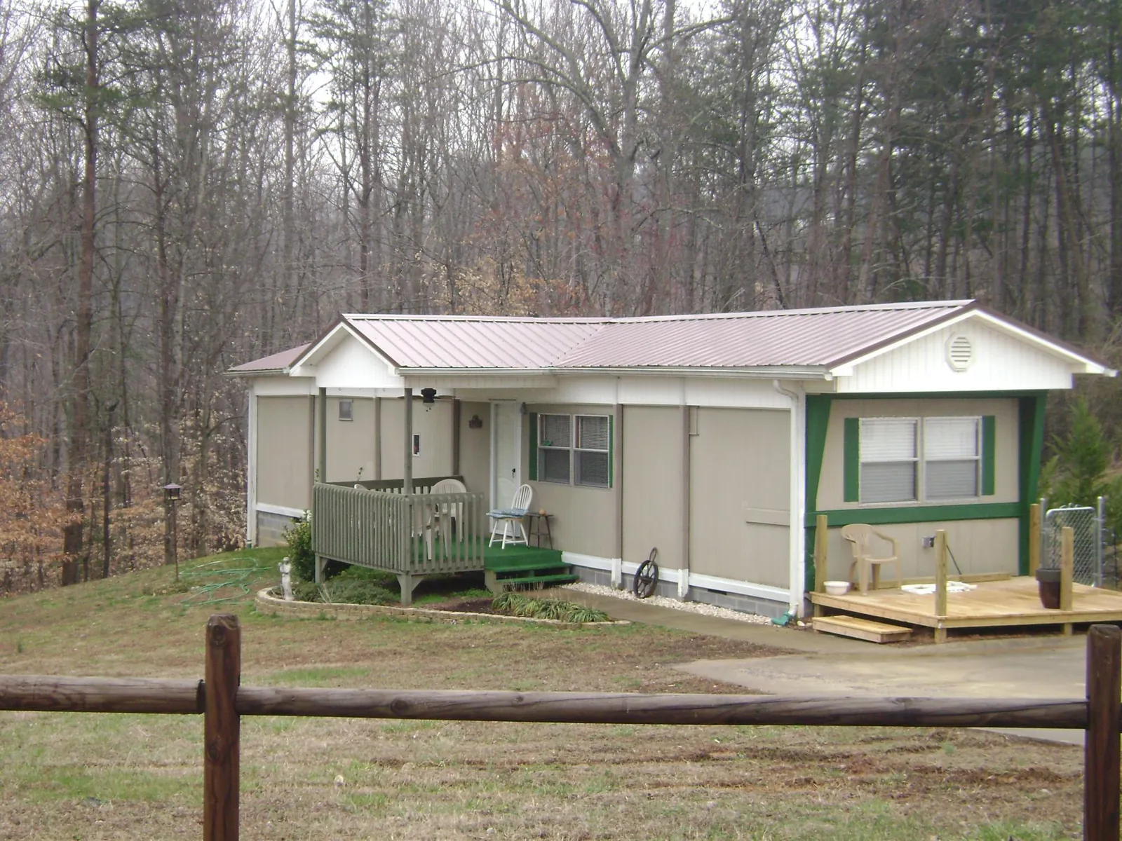 Mauve metal roof on a manufactured home with a new front deck in Cross River